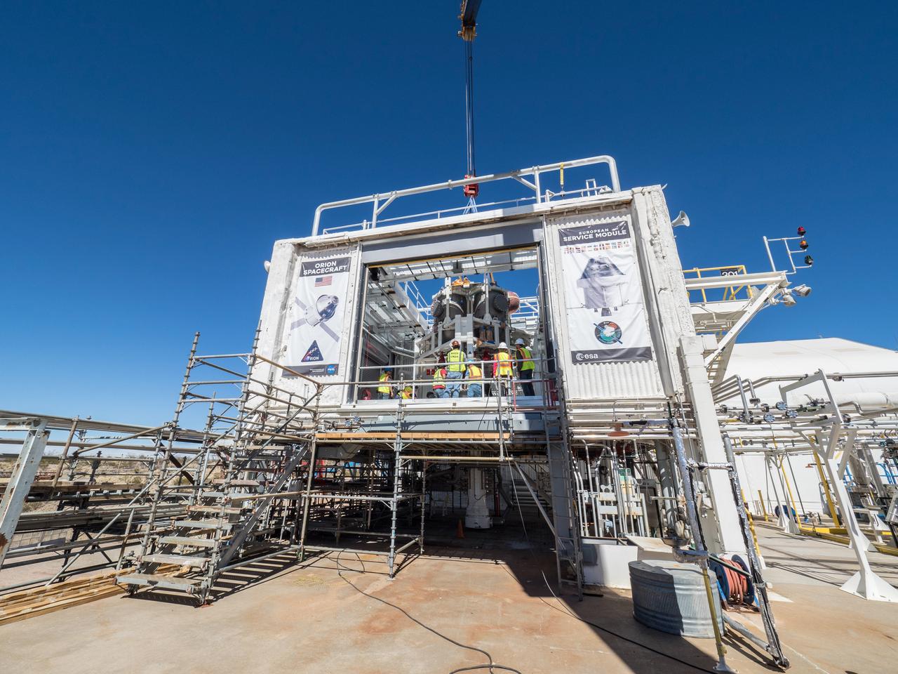 On Feb. 22, engineers successfully install ESA’s European Service Module Propulsion Qualification Module (PQM) at NASA’s White Sands Test Facility in New Mexico that was delivered by Airbus – ESA’s prime contractor for the Service Module. The module will be equipped with a total of 21 engines to support NASA’s Orion spacecraft: one U.S. Space Shuttle Orbital Maneuvering System (OMS) engine, eight auxiliary thrusters and 12 smaller thrusters produced by Airbus Safran Launchers in Germany. The all-steel PQM structure is used to test the propulsion systems on Orion, including “hot firing” of the OMS engine and thrusters.