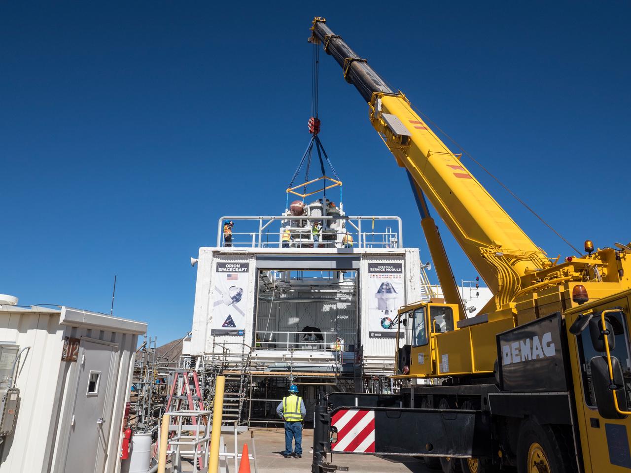 On Feb. 22, engineers successfully install ESA’s European Service Module Propulsion Qualification Module (PQM) at NASA’s White Sands Test Facility in New Mexico that was delivered by Airbus – ESA’s prime contractor for the Service Module. The module will be equipped with a total of 21 engines to support NASA’s Orion spacecraft: one U.S. Space Shuttle Orbital Maneuvering System (OMS) engine, eight auxiliary thrusters and 12 smaller thrusters produced by Airbus Safran Launchers in Germany. The all-steel PQM structure is used to test the propulsion systems on Orion, including “hot firing” of the OMS engine and thrusters.
