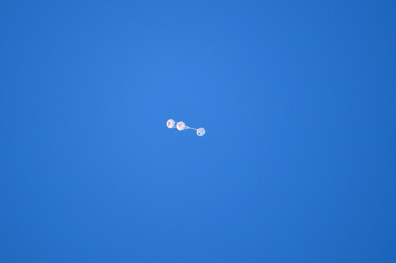 Orion’s three main orange and white parachutes help a representative model of the spacecraft descend through sky above Arizona, where NASA engineers tested the parachute system on Sept. 13, 2017 at the U.S. Army Proving Ground in Yuma. NASA is qualifying Orion’s parachutes for missions with astronauts.. .During this test, engineers replicated a situation in which Orion must abort off the Space Launch System rocket and bypasses part of its normal parachute deployment sequence that typically helps the spacecraft slow down during its descent to Earth after deep space missions. The capsule was dropped out of a C-17 aircraft at more than 4.7 miles in altitude and allowed to free fall for 20 seconds, longer than ever before, to produce high aerodynamic pressure before only its pilot and main parachutes were deployed, testing whether they could perform as expected under extreme loads. Orion’s full parachute system includes 11 total parachutes -- three forward bay cover parachutes and two drogue parachutes, along with three pilot parachutes that help pull out the spacecraft’s three mains.