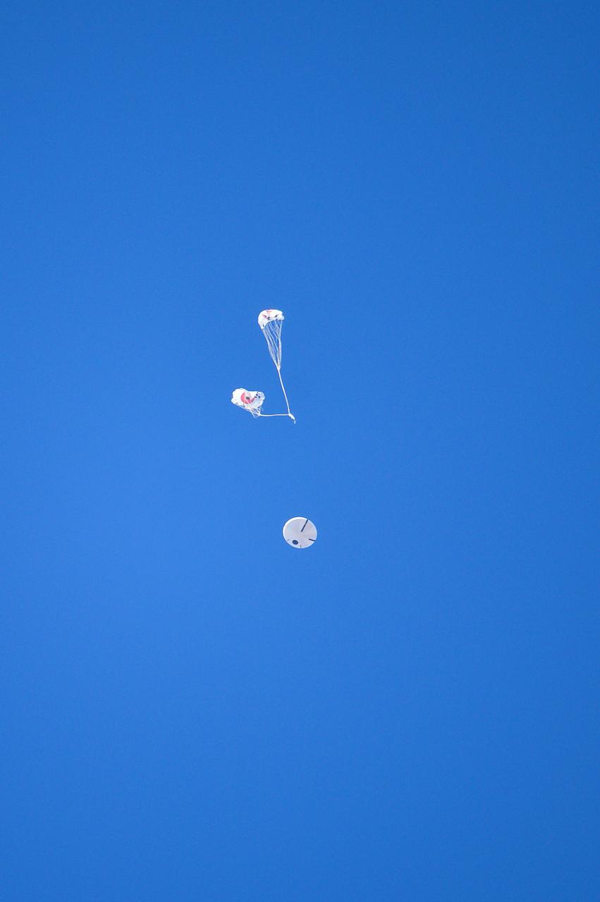 Orion’s three main orange and white parachutes help a representative model of the spacecraft descend through sky above Arizona, where NASA engineers tested the parachute system on Sept. 13, 2017 at the U.S. Army Proving Ground in Yuma. NASA is qualifying Orion’s parachutes for missions with astronauts.. .During this test, engineers replicated a situation in which Orion must abort off the Space Launch System rocket and bypasses part of its normal parachute deployment sequence that typically helps the spacecraft slow down during its descent to Earth after deep space missions. The capsule was dropped out of a C-17 aircraft at more than 4.7 miles in altitude and allowed to free fall for 20 seconds, longer than ever before, to produce high aerodynamic pressure before only its pilot and main parachutes were deployed, testing whether they could perform as expected under extreme loads. Orion’s full parachute system includes 11 total parachutes -- three forward bay cover parachutes and two drogue parachutes, along with three pilot parachutes that help pull out the spacecraft’s three mains.