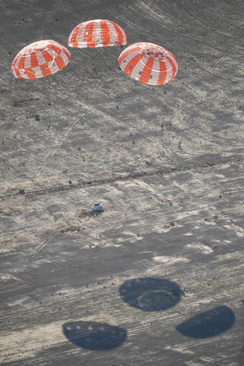 Orion’s three main orange and white parachutes help a representative model of the spacecraft descend through sky above Arizona, where NASA engineers tested the parachute system on Sept. 13, 2017 at the U.S. Army Proving Ground in Yuma. NASA is qualifying Orion’s parachutes for missions with astronauts.. .During this test, engineers replicated a situation in which Orion must abort off the Space Launch System rocket and bypasses part of its normal parachute deployment sequence that typically helps the spacecraft slow down during its descent to Earth after deep space missions. The capsule was dropped out of a C-17 aircraft at more than 4.7 miles in altitude and allowed to free fall for 20 seconds, longer than ever before, to produce high aerodynamic pressure before only its pilot and main parachutes were deployed, testing whether they could perform as expected under extreme loads. Orion’s full parachute system includes 11 total parachutes -- three forward bay cover parachutes and two drogue parachutes, along with three pilot parachutes that help pull out the spacecraft’s three mains.