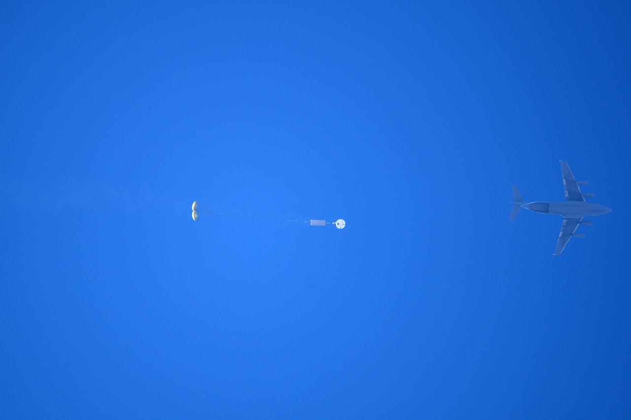 Orion’s three main orange and white parachutes help a representative model of the spacecraft descend through sky above Arizona, where NASA engineers tested the parachute system on Sept. 13, 2017 at the U.S. Army Proving Ground in Yuma. NASA is qualifying Orion’s parachutes for missions with astronauts.. .During this test, engineers replicated a situation in which Orion must abort off the Space Launch System rocket and bypasses part of its normal parachute deployment sequence that typically helps the spacecraft slow down during its descent to Earth after deep space missions. The capsule was dropped out of a C-17 aircraft at more than 4.7 miles in altitude and allowed to free fall for 20 seconds, longer than ever before, to produce high aerodynamic pressure before only its pilot and main parachutes were deployed, testing whether they could perform as expected under extreme loads. Orion’s full parachute system includes 11 total parachutes -- three forward bay cover parachutes and two drogue parachutes, along with three pilot parachutes that help pull out the spacecraft’s three mains.