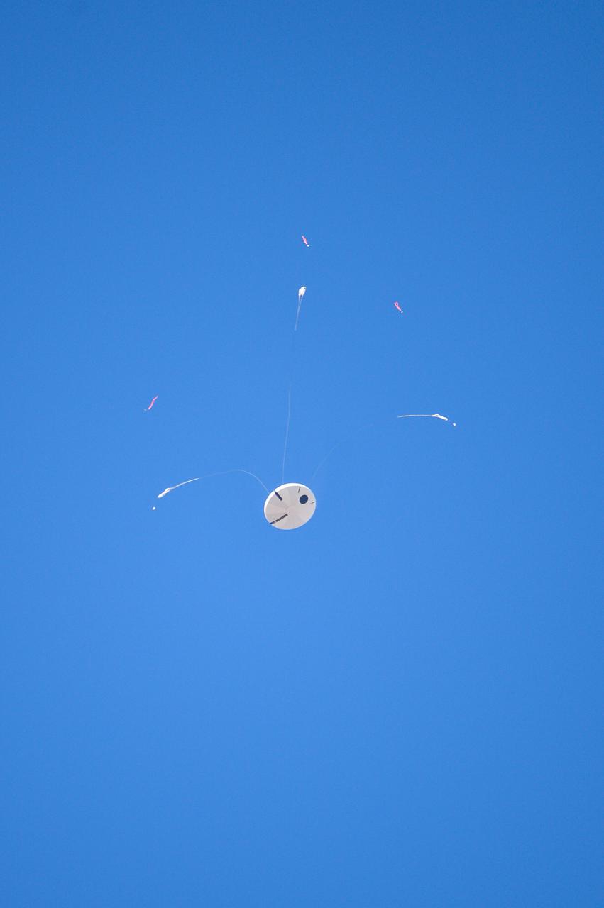Orion’s three main orange and white parachutes help a representative model of the spacecraft descend through sky above Arizona, where NASA engineers tested the parachute system on Sept. 13, 2017 at the U.S. Army Proving Ground in Yuma. NASA is qualifying Orion’s parachutes for missions with astronauts.. .During this test, engineers replicated a situation in which Orion must abort off the Space Launch System rocket and bypasses part of its normal parachute deployment sequence that typically helps the spacecraft slow down during its descent to Earth after deep space missions. The capsule was dropped out of a C-17 aircraft at more than 4.7 miles in altitude and allowed to free fall for 20 seconds, longer than ever before, to produce high aerodynamic pressure before only its pilot and main parachutes were deployed, testing whether they could perform as expected under extreme loads. Orion’s full parachute system includes 11 total parachutes -- three forward bay cover parachutes and two drogue parachutes, along with three pilot parachutes that help pull out the spacecraft’s three mains.