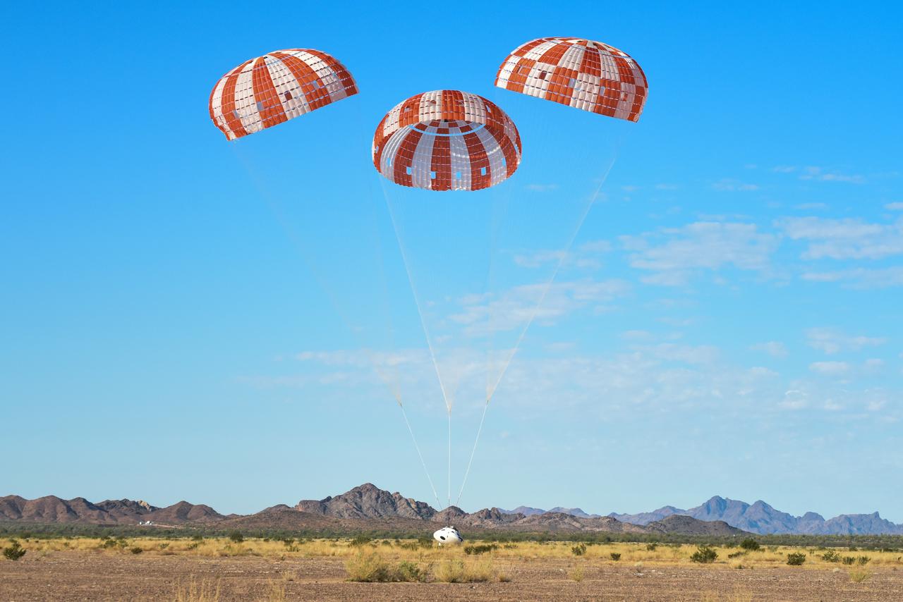 Orion’s three main orange and white parachutes help a representative model of the spacecraft descend through sky above Arizona, where NASA engineers tested the parachute system on Sept. 13, 2017 at the U.S. Army Proving Ground in Yuma. NASA is qualifying Orion’s parachutes for missions with astronauts.. .During this test, engineers replicated a situation in which Orion must abort off the Space Launch System rocket and bypasses part of its normal parachute deployment sequence that typically helps the spacecraft slow down during its descent to Earth after deep space missions. The capsule was dropped out of a C-17 aircraft at more than 4.7 miles in altitude and allowed to free fall for 20 seconds, longer than ever before, to produce high aerodynamic pressure before only its pilot and main parachutes were deployed, testing whether they could perform as expected under extreme loads. Orion’s full parachute system includes 11 total parachutes -- three forward bay cover parachutes and two drogue parachutes, along with three pilot parachutes that help pull out the spacecraft’s three mains.
