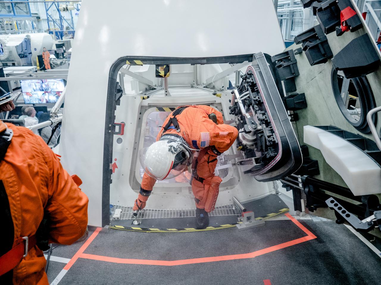 NASA is performing a series of tests to evaluate how astronauts and ground crew involved in final preparations before Orion missions will quickly get out of the spacecraft if an emergency were to occur on the pad prior to launch. In the hours before astronauts launch to space in Orion from NASA’s modernized spaceport in Florida in on the agency’s Space Launch System rocket, they will cross the Crew Access Arm 300 feet above the ground and climb inside the crew module with the assistance of ground personnel trained to help them strap into their seats and take care of last-minute needs. The testing is helping engineers evaluate hardware designs and establish procedures that would be used to get astronauts and ground crew out of the capsule as quickly as possible. Flight and ground crew are required to get out of Orion within two minutes to protect for a variety of failure scenarios that do not require the launch abort system to be activated, such as crew incapacitation, fire or the presence of toxins in the cabin. This testing took place the week of Oct. 30, 2017 using the Orion mockup in the Space Vehicle Mockup Facility at NASA’s Johnson Space Center in Houston. In this photo, engineers used fake smoke to imitate a scenario in which astronauts must exit the capsule when their vision is obscured. Markings on the ground indicate where the Crew Access Arm would be located and help guide the crew. This testing is a collaborative effort between the Orion and Ground Systems Development and Operations programs. Previous egress testing at Johnson and in the Gulf of Mexico has evaluated how crew will exit the spacecraft at the end of their missions..