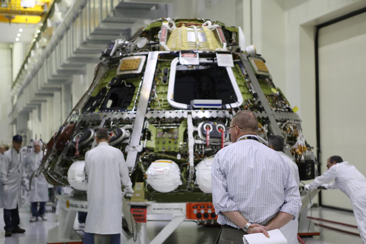 Technicians assist as the Orion crew module for Artemis I is moved toward the thermal chamber in the Neil Armstrong Operations and Checkout Building high bay at NASA's Kennedy Space Center in Florida on Nov. 17, 2017. The crew module will undergo a thermal cycle test to assess the workmanship of critical hardware and structural locations. The test also demonstrates crew module subsystem operations in a thermally stressing environment to confirm no damage or anomalous hardware conditions as a result of the test. The Orion spacecraft will launch atop NASA's Space Launch System rocket on its first uncrewed integrated flight.