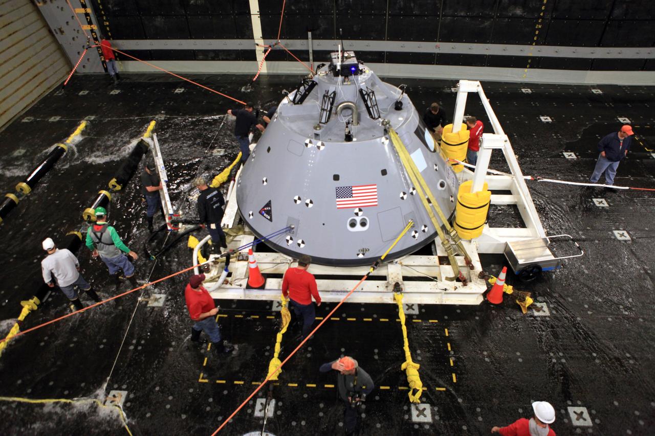 After a day of working with the Orion test article under rough seas on Jan. 19, 2018, the NASA Recovery Team inspects the capsule and their lines. As part of Underway Recovery Test 6, the Orion test article was intentionally subjected to an increased sea state to ensure the team could control the spacecraft under all possible scenarios. The testing with Kennedy Space Center's NASA Recovery Team and the U.S. Navy will provide important data that is being used to improve recovery procedures and hardware ahead of Orion's next flight, Artemis I, when it splashes down in the Pacific Ocean.