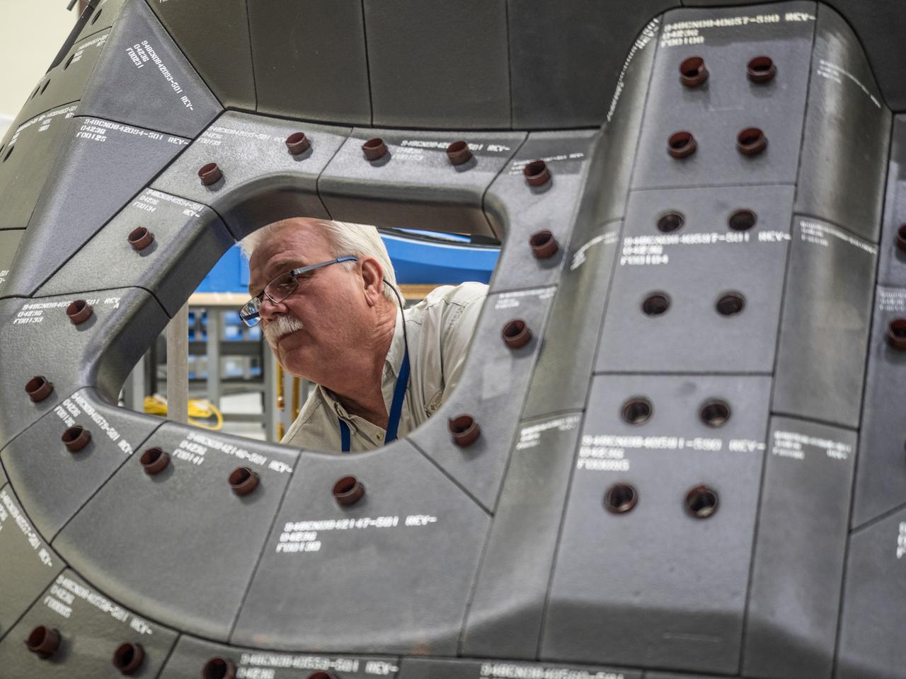 Lockheed Martin engineers assemble Orion's Artemis I crew module at NASA's Kennedy Space Center Operations and Checkout Building on April 27, 2018.