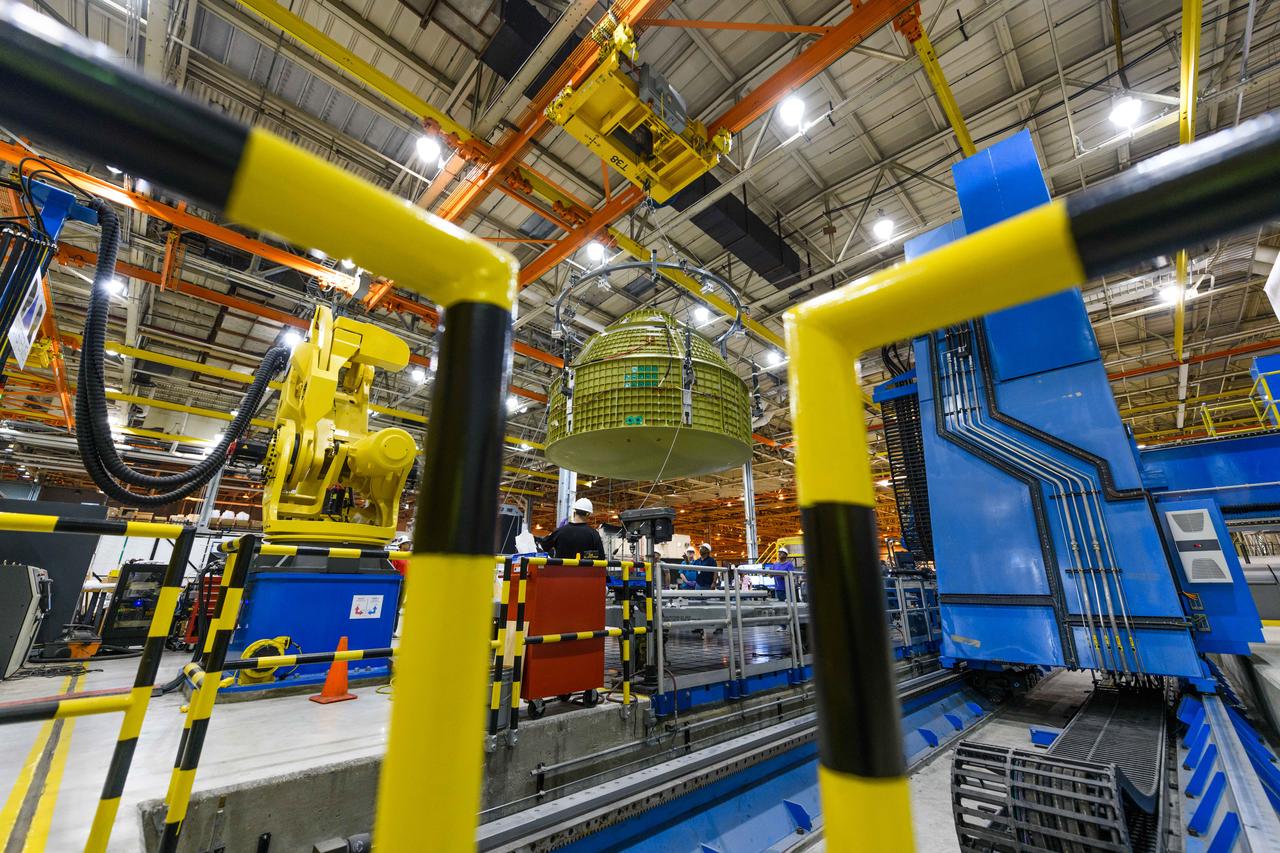 Lockheed Martin technicians at NASA's Michoud Assembly Facility in New Orleans, Louisiana, complete the final weld on the pressure vessel of the Orion crew module for Artemis II on July 24, 2018, the first flight of Orion with astronauts which will carry them farther into the solar system than ever before.