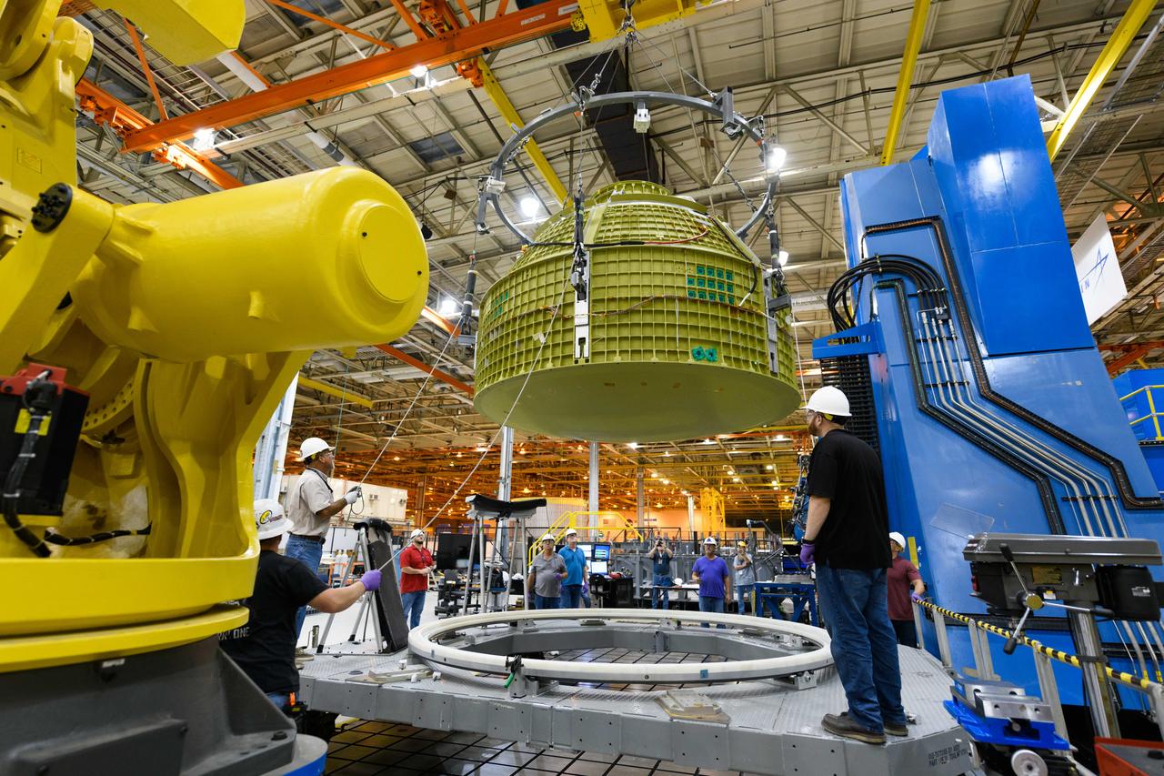 Lockheed Martin technicians at NASA's Michoud Assembly Facility in New Orleans, Louisiana, complete the final weld on the pressure vessel of the Orion crew module for Artemis II on July 24, 2018, the first flight of Orion with astronauts which will carry them farther into the solar system than ever before.