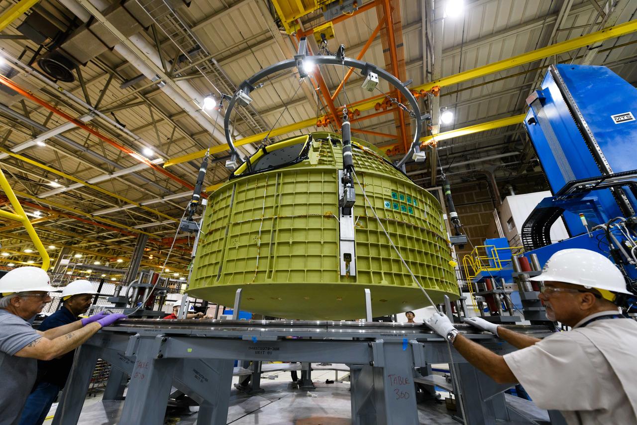 Lockheed Martin technicians at NASA's Michoud Assembly Facility in New Orleans, Louisiana, complete the final weld on the pressure vessel of the Orion crew module for Artemis II on July 24, 2018, the first flight of Orion with astronauts which will carry them farther into the solar system than ever before.