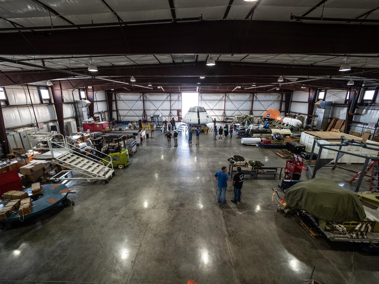 The Orion team prepares the parachute test vehicle for the final drop test which will qualify Orion's parachutes for human flight on Sept. 10, 2018...On September 12, 2018 an Orion test capsule will be dropped from a C-17 aircraft at an altitude of more than six miles to verify the spacecraft’s complex system of 11 parachutes, cannon-like mortars, and pyrotechnic devices work in sequence to slow the capsule’s descent for a safe landing on Earth.