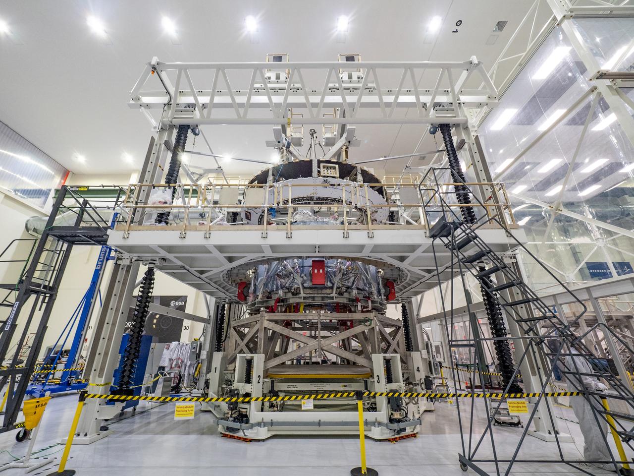 At the Operations and Checkout Building at Kennedy Space Center, Lockheed Martin technicians work to mate Orion's crew module adapter to the European Service Module on Nov. 13, 2018...For the first time, NASA will use a European-built system as a critical element to power an American spacecraft, extending the international cooperation of the International Space Station into deep space. The European Service Module is a unique collaboration across space agencies and industry including ESA’s prime contractor, Airbus, and 10 European countries. The completion of service module work in Europe and shipment to Kennedy signifies a major milestone toward NASA’s human deep space exploration missions to the Moon and beyond.