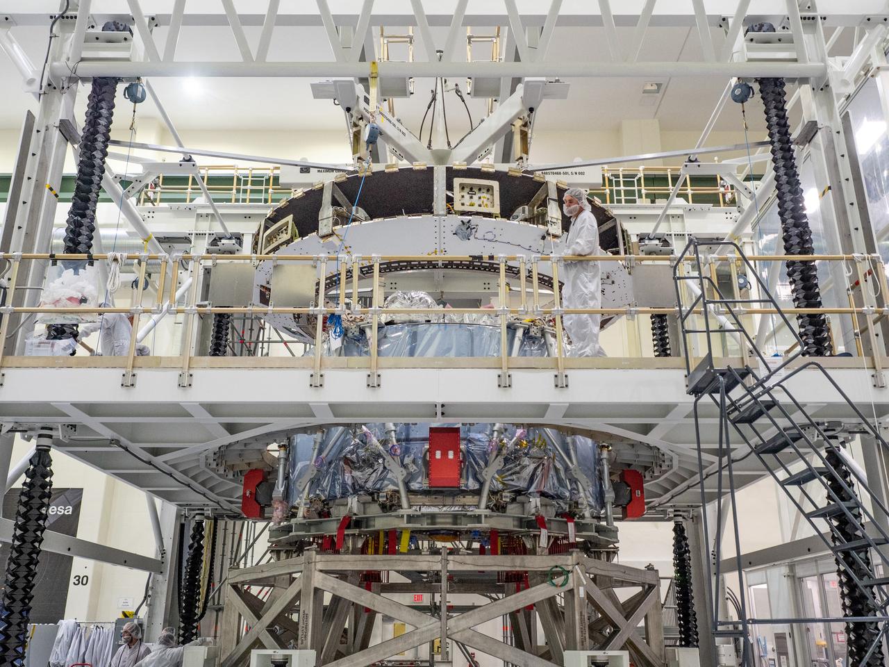 At the Operations and Checkout Building at Kennedy Space Center, Lockheed Martin technicians work to mate Orion's crew module adapter to the European Service Module on Nov. 13, 2018...For the first time, NASA will use a European-built system as a critical element to power an American spacecraft, extending the international cooperation of the International Space Station into deep space. The European Service Module is a unique collaboration across space agencies and industry including ESA’s prime contractor, Airbus, and 10 European countries. The completion of service module work in Europe and shipment to Kennedy signifies a major milestone toward NASA’s human deep space exploration missions to the Moon and beyond.