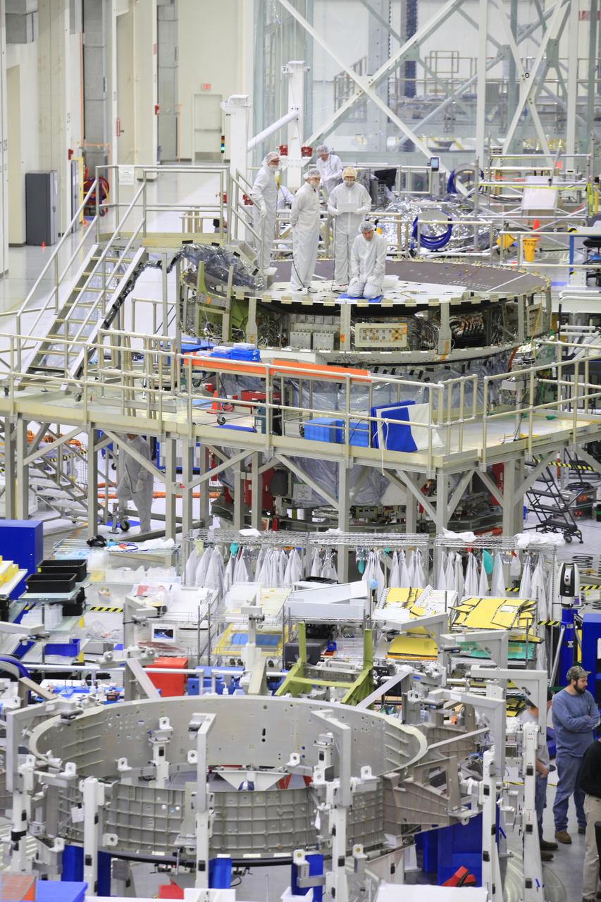 The crew and service module for Artemis I continue preparations for mating inside the Operations and Checkout (O&C) Building High Bay at Kennedy Space Center on March 21, 2019. Alongside, the pressure vessel for Artemis II is undergoing install of its secondary structure.