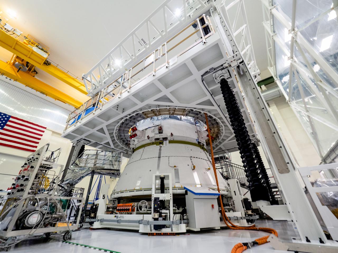 On April 29, Orion’s service module, shown here on May 2, 2019, moved to the lift station inside the assembly bay for installation and fastening of systems in preparation for Direct Field Acoustics Test (DFAT). The service module will move down to the east end of the bay next week where it will be surrounded with speakers and exposed to the acoustic level that will be experienced in space.