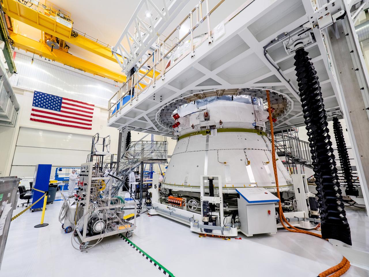 On April 29, Orion’s service module, shown here on May 2, 2019, moved to the lift station inside the assembly bay for installation and fastening of systems in preparation for Direct Field Acoustics Test (DFAT). The service module will move down to the east end of the bay next week where it will be surrounded with speakers and exposed to the acoustic level that will be experienced in space.