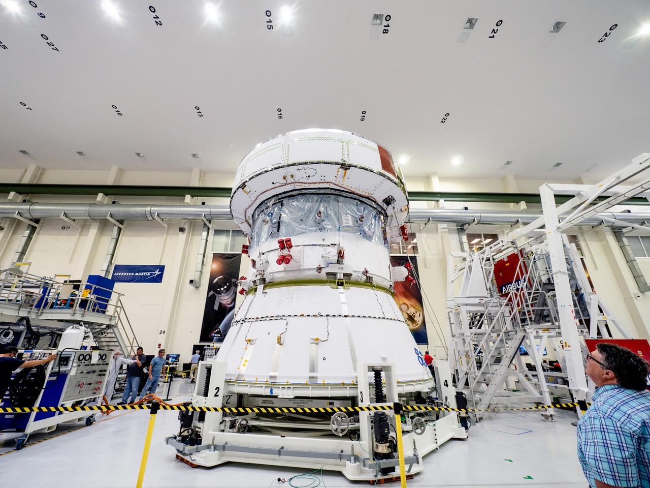 On April 29, Orion’s Service Module, shown here on May 3, 2019, moved to the lift station inside the assembly bay for installation and fastening of systems in preparation for Direct Field Acoustics Test (DFAT). The Service Module will move down to the east end of the bay next week where it will be surrounded with speakers and exposed to the acoustic level that will be experienced in space.