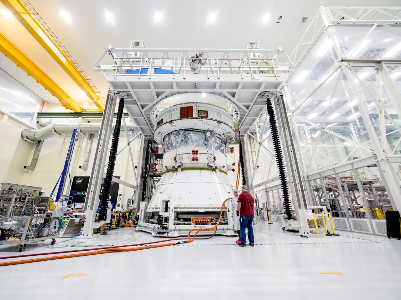 On April 29, Orion’s Service Module, shown here on May 3, 2019, moved to the lift station inside the assembly bay for installation and fastening of systems in preparation for Direct Field Acoustics Test (DFAT). The Service Module will move down to the east end of the bay next week where it will be surrounded with speakers and exposed to the acoustic level that will be experienced in space.