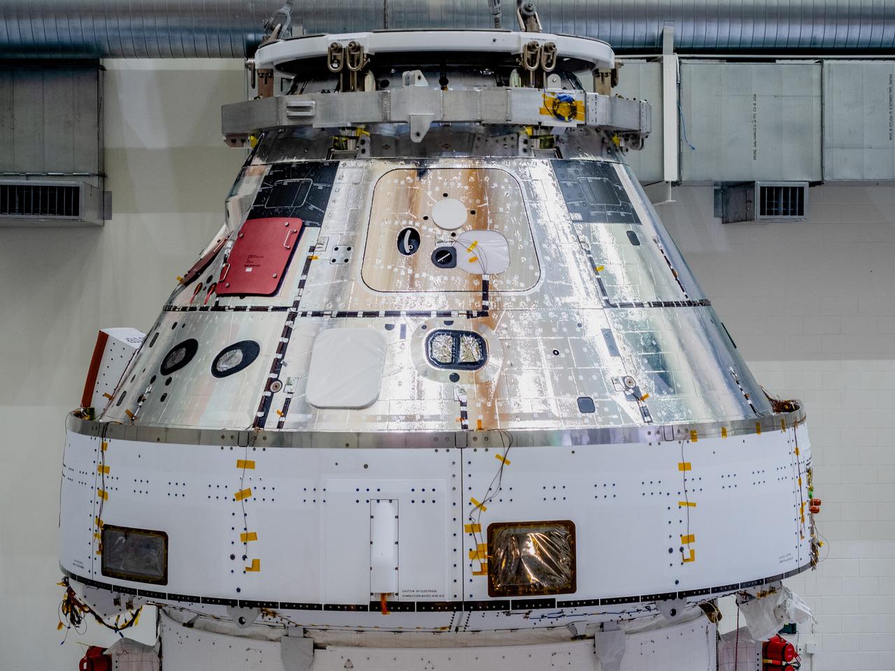 The Orion crew and service module stack for Artemis I was lifted out of the Final Assembly and Test (FAST) cell on November 11, 2019. The spacecraft has been stationed in the FAST cell since July for mating and closeout processing. The service module and crew module were moved separately into the cell, stacked and connected together for the mission. After lifting out of the cell, Orion will be attached to a tool called a verticator that rotates the stack from its vertical configuration to a horizontal configuration for transport to NASA’s Plum Brook Station in Sandusky, Ohio, where it will undergo full environmental testing to certify the complete vehicle for flight. Once the vehicle returns to Kennedy in several months, it will return to the FAST cell for installation of final panels left off for environmental testing purposes and the service module’s four solar arrays.