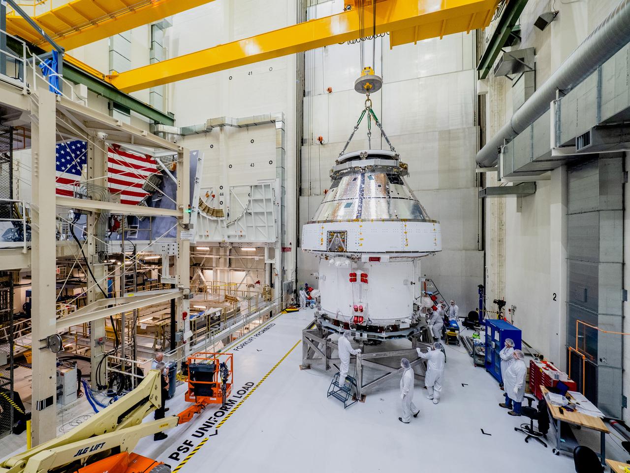 The Orion crew and service module stack for Artemis I was lifted out of the Final Assembly and Test (FAST) cell on November 11, 2019. The spacecraft has been stationed in the FAST cell since July for mating and closeout processing. The service module and crew module were moved separately into the cell, stacked and connected together for the mission. After lifting out of the cell, Orion will be attached to a tool called a verticator that rotates the stack from its vertical configuration to a horizontal configuration for transport to NASA’s Plum Brook Station in Sandusky, Ohio, where it will undergo full environmental testing to certify the complete vehicle for flight. Once the vehicle returns to Kennedy in several months, it will return to the FAST cell for installation of final panels left off for environmental testing purposes and the service module’s four solar arrays.