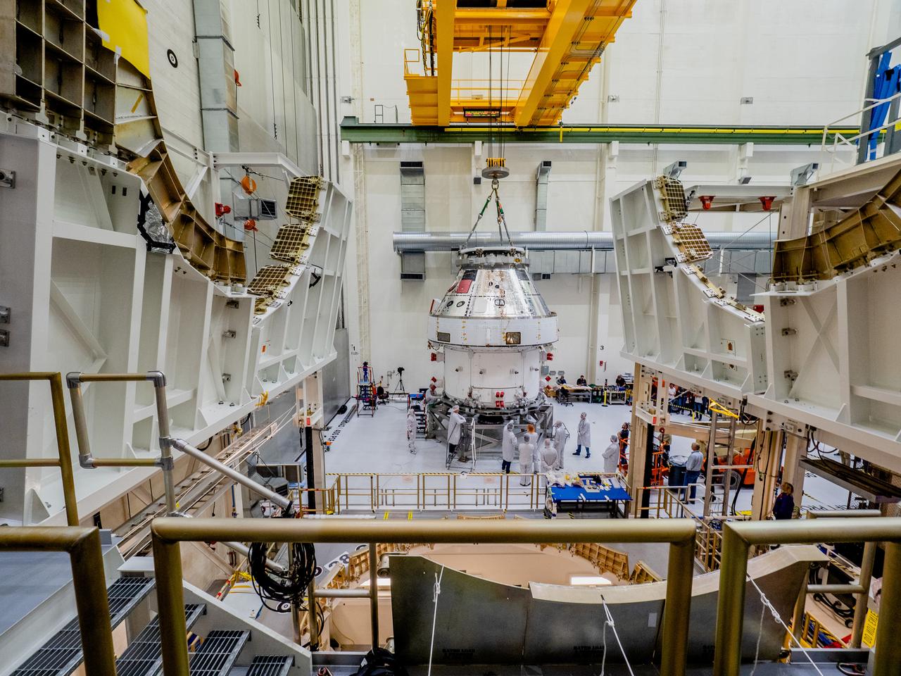 The Orion crew and service module stack for Artemis I was lifted out of the Final Assembly and Test (FAST) cell on November 11, 2019. The spacecraft has been stationed in the FAST cell since July for mating and closeout processing. The service module and crew module were moved separately into the cell, stacked and connected together for the mission. After lifting out of the cell, Orion will be attached to a tool called a verticator that rotates the stack from its vertical configuration to a horizontal configuration for transport to NASA’s Plum Brook Station in Sandusky, Ohio, where it will undergo full environmental testing to certify the complete vehicle for flight. Once the vehicle returns to Kennedy in several months, it will return to the FAST cell for installation of final panels left off for environmental testing purposes and the service module’s four solar arrays.