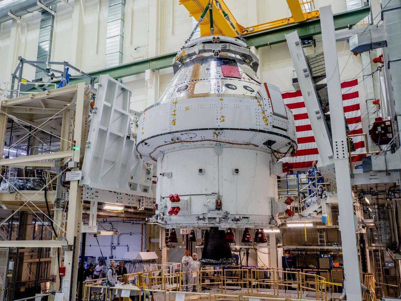 The Orion crew and service module stack for Artemis I was lifted out of the Final Assembly and Test (FAST) cell on November 11, 2019. The spacecraft has been stationed in the FAST cell since July for mating and closeout processing. The service module and crew module were moved separately into the cell, stacked and connected together for the mission. After lifting out of the cell, Orion will be attached to a tool called a verticator that rotates the stack from its vertical configuration to a horizontal configuration for transport to NASA’s Plum Brook Station in Sandusky, Ohio, where it will undergo full environmental testing to certify the complete vehicle for flight. Once the vehicle returns to Kennedy in several months, it will return to the FAST cell for installation of final panels left off for environmental testing purposes and the service module’s four solar arrays.