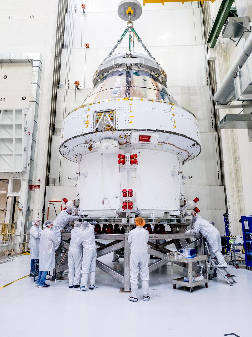 The Orion crew and service module stack for Artemis I was lifted out of the Final Assembly and Test (FAST) cell on November 11, 2019. The spacecraft has been stationed in the FAST cell since July for mating and closeout processing. The service module and crew module were moved separately into the cell, stacked and connected together for the mission. After lifting out of the cell, Orion will be attached to a tool called a verticator that rotates the stack from its vertical configuration to a horizontal configuration for transport to NASA’s Plum Brook Station in Sandusky, Ohio, where it will undergo full environmental testing to certify the complete vehicle for flight. Once the vehicle returns to Kennedy in several months, it will return to the FAST cell for installation of final panels left off for environmental testing purposes and the service module’s four solar arrays.