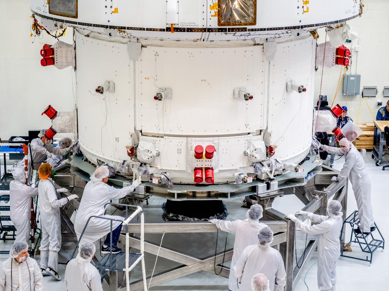 The Orion crew and service module stack for Artemis I was lifted out of the Final Assembly and Test (FAST) cell on November 11, 2019. The spacecraft has been stationed in the FAST cell since July for mating and closeout processing. The service module and crew module were moved separately into the cell, stacked and connected together for the mission. After lifting out of the cell, Orion will be attached to a tool called a verticator that rotates the stack from its vertical configuration to a horizontal configuration for transport to NASA’s Plum Brook Station in Sandusky, Ohio, where it will undergo full environmental testing to certify the complete vehicle for flight. Once the vehicle returns to Kennedy in several months, it will return to the FAST cell for installation of final panels left off for environmental testing purposes and the service module’s four solar arrays.