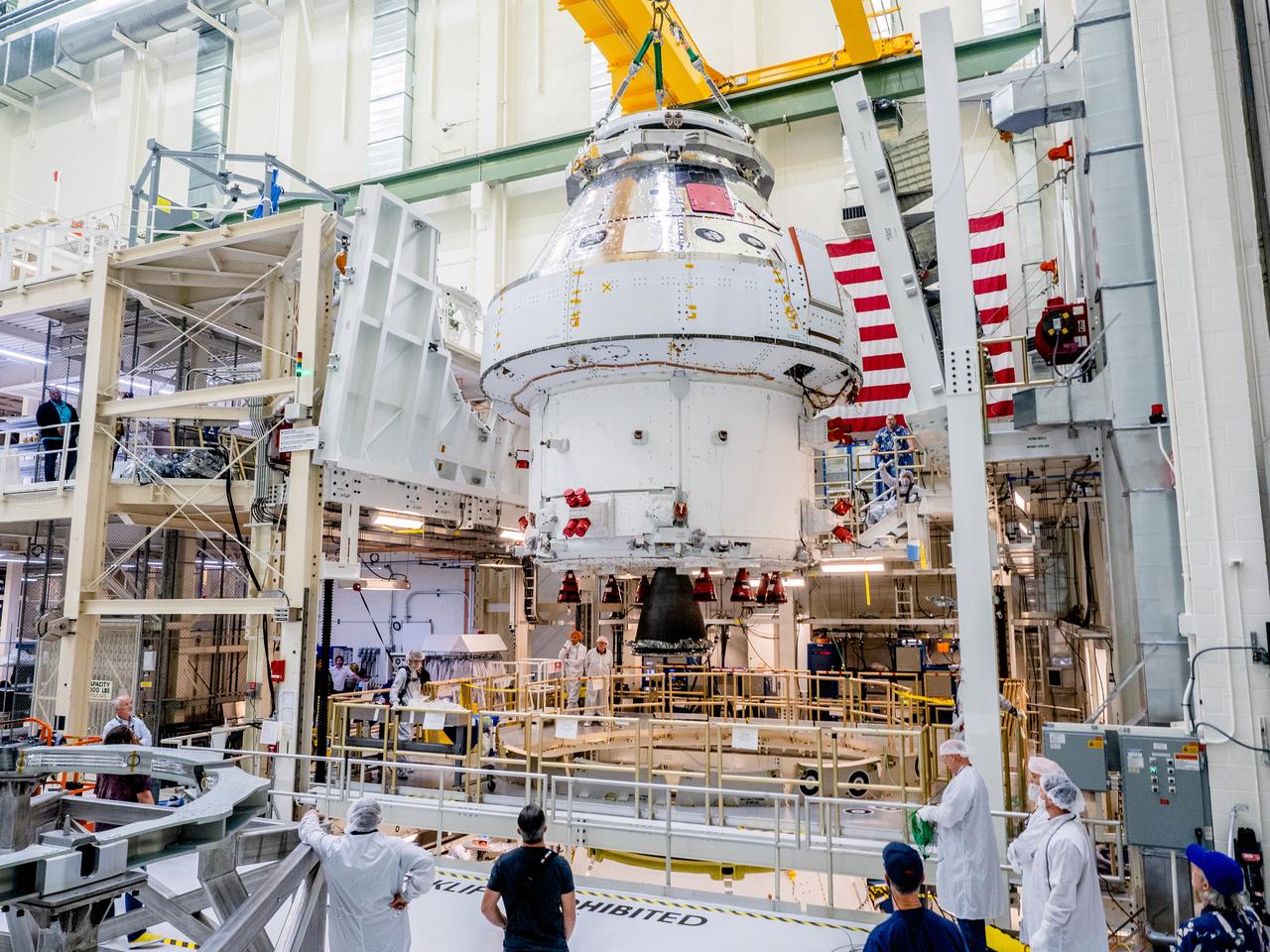 The Orion crew and service module stack for Artemis I was lifted out of the Final Assembly and Test (FAST) cell on November 11, 2019. The spacecraft has been stationed in the FAST cell since July for mating and closeout processing. The service module and crew module were moved separately into the cell, stacked and connected together for the mission. After lifting out of the cell, Orion will be attached to a tool called a verticator that rotates the stack from its vertical configuration to a horizontal configuration for transport to NASA’s Plum Brook Station in Sandusky, Ohio, where it will undergo full environmental testing to certify the complete vehicle for flight. Once the vehicle returns to Kennedy in several months, it will return to the FAST cell for installation of final panels left off for environmental testing purposes and the service module’s four solar arrays.