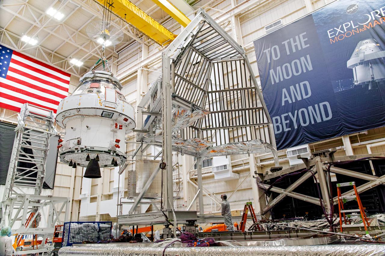 NASA’s Orion spacecraft–the crew module and European-built service module—is being lifted on Dec. 1, 2019 into a thermal cage and readied for its move into the vacuum chamber at NASA’s Neil A. Armstrong Test Facility in Ohio (formerly Plum Brook Station) for testing. Testing begins with a 60-day thermal test, where the spacecraft will be subjected to temperatures ranging from -250 to 300-degrees Fahrenheit to ensure it can withstand the harsh environment of space during Artemis missions. These extreme temperatures simulate flying in-and-out of sunlight and shadow in space using Heat Flux, a specially-designed system that heats specific parts of the spacecraft at any given time. Orion will also be surrounded on all sides by a set of large panels, called a cryogenic-shroud, that will provide the cold background temperatures of space.