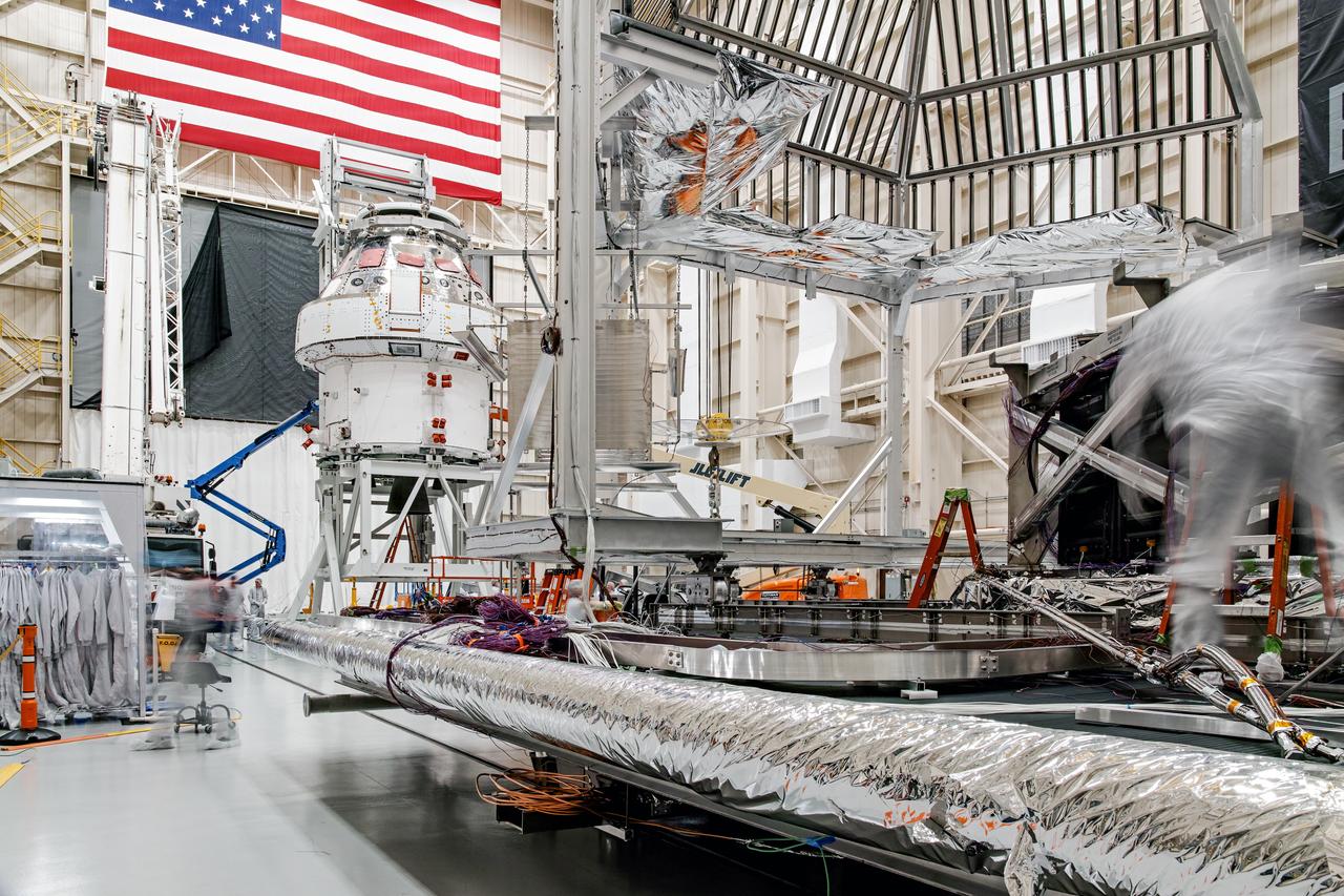 NASA’s Orion spacecraft–the crew module and European-built service module—is being lifted on Dec. 1, 2019 into a thermal cage and readied for its move into the vacuum chamber at NASA’s Neil A. Armstrong Test Facility in Ohio (formerly Plum Brook Station) for testing. Testing begins with a 60-day thermal test, where the spacecraft will be subjected to temperatures ranging from -250 to 300-degrees Fahrenheit to ensure it can withstand the harsh environment of space during Artemis missions. These extreme temperatures simulate flying in-and-out of sunlight and shadow in space using Heat Flux, a specially-designed system that heats specific parts of the spacecraft at any given time. Orion will also be surrounded on all sides by a set of large panels, called a cryogenic-shroud, that will provide the cold background temperatures of space.