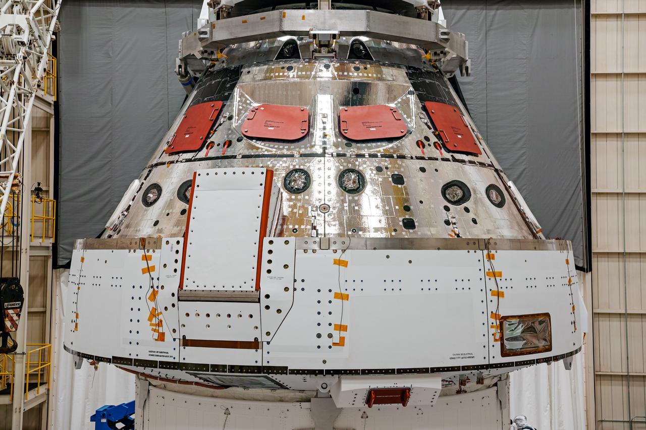 NASA’s Orion spacecraft–the crew module and European-built service module—is being lifted on Dec. 1, 2019 into a thermal cage and readied for its move into the vacuum chamber at NASA’s Neil A. Armstrong Test Facility in Ohio (formerly Plum Brook Station) for testing. Testing begins with a 60-day thermal test, where the spacecraft will be subjected to temperatures ranging from -250 to 300-degrees Fahrenheit to ensure it can withstand the harsh environment of space during Artemis missions. These extreme temperatures simulate flying in-and-out of sunlight and shadow in space using Heat Flux, a specially-designed system that heats specific parts of the spacecraft at any given time. Orion will also be surrounded on all sides by a set of large panels, called a cryogenic-shroud, that will provide the cold background temperatures of space.