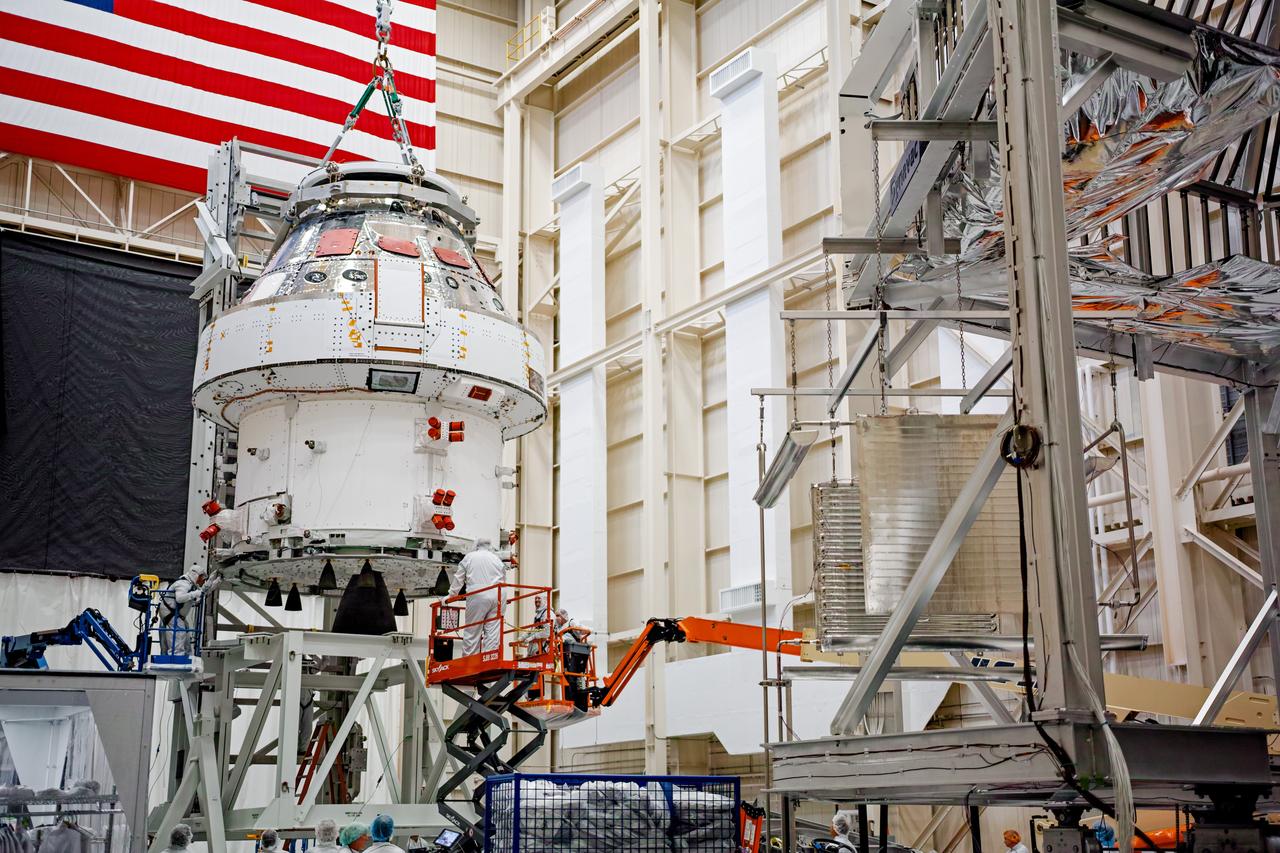 NASA’s Orion spacecraft–the crew module and European-built service module—is being lifted on Dec. 1, 2019 into a thermal cage and readied for its move into the vacuum chamber at NASA’s Neil A. Armstrong Test Facility in Ohio (formerly Plum Brook Station) for testing. Testing begins with a 60-day thermal test, where the spacecraft will be subjected to temperatures ranging from -250 to 300-degrees Fahrenheit to ensure it can withstand the harsh environment of space during Artemis missions. These extreme temperatures simulate flying in-and-out of sunlight and shadow in space using Heat Flux, a specially-designed system that heats specific parts of the spacecraft at any given time. Orion will also be surrounded on all sides by a set of large panels, called a cryogenic-shroud, that will provide the cold background temperatures of space.
