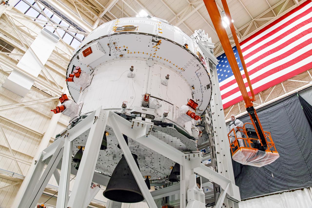 NASA’s Orion spacecraft–the crew module and European-built service module—is being lifted on Dec. 1, 2019 into a thermal cage and readied for its move into the vacuum chamber at NASA’s Neil A. Armstrong Test Facility in Ohio (formerly Plum Brook Station) for testing. Testing begins with a 60-day thermal test, where the spacecraft will be subjected to temperatures ranging from -250 to 300-degrees Fahrenheit to ensure it can withstand the harsh environment of space during Artemis missions. These extreme temperatures simulate flying in-and-out of sunlight and shadow in space using Heat Flux, a specially-designed system that heats specific parts of the spacecraft at any given time. Orion will also be surrounded on all sides by a set of large panels, called a cryogenic-shroud, that will provide the cold background temperatures of space.