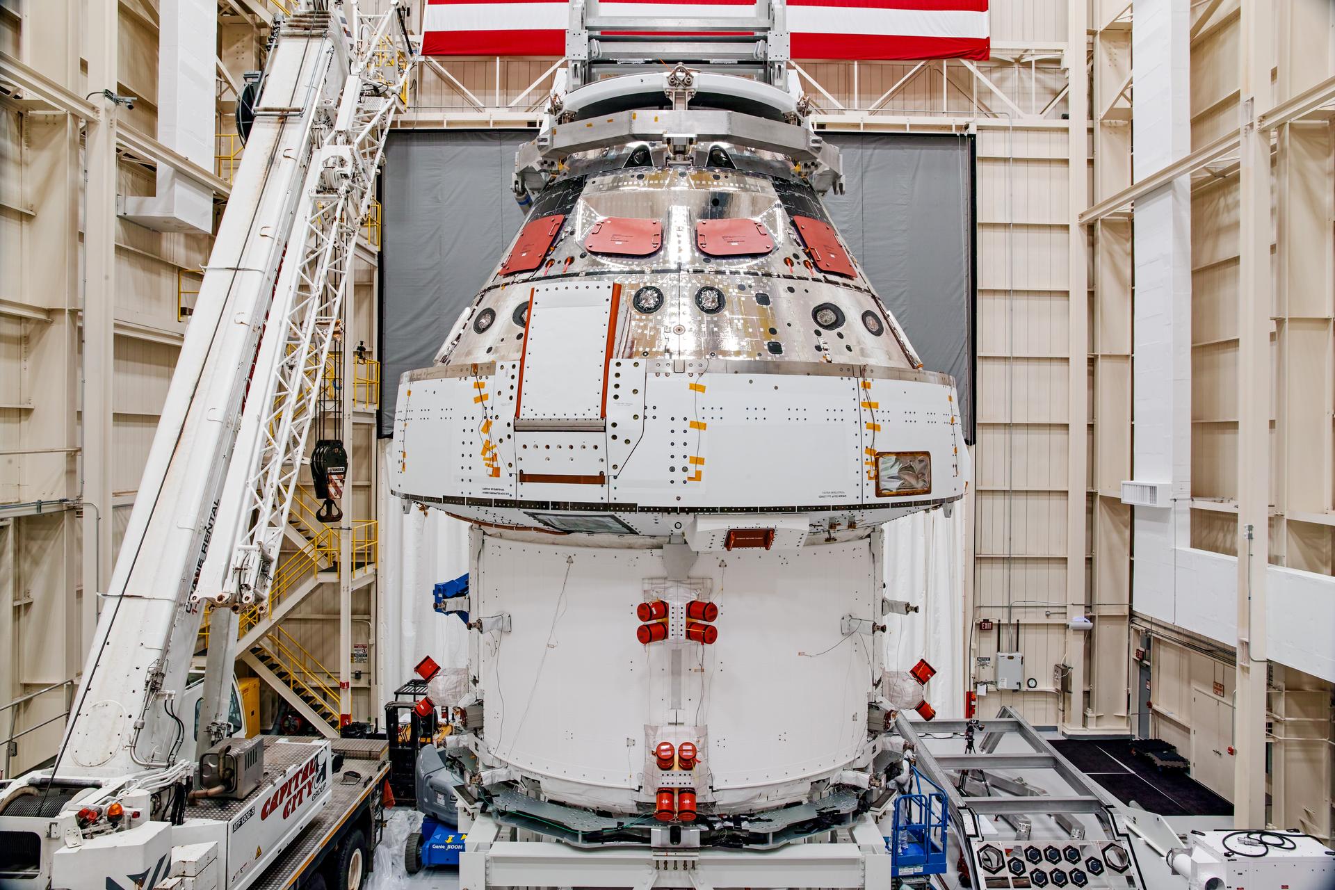 NASA’s Orion spacecraft–the crew module and European-built service module—is being lifted on Dec. 1, 2019 into a thermal cage and readied for its move into the vacuum chamber at NASA’s Neil A. Armstrong Test Facility in Ohio (formerly Plum Brook Station) for testing. Testing begins with a 60-day thermal test, where the spacecraft will be subjected to temperatures ranging from -250 to 300-degrees Fahrenheit to ensure it can withstand the harsh environment of space during Artemis missions. These extreme temperatures simulate flying in-and-out of sunlight and shadow in space using Heat Flux, a specially-designed system that heats specific parts of the spacecraft at any given time. Orion will also be surrounded on all sides by a set of large panels, called a cryogenic-shroud, that will provide the cold background temperatures of space.