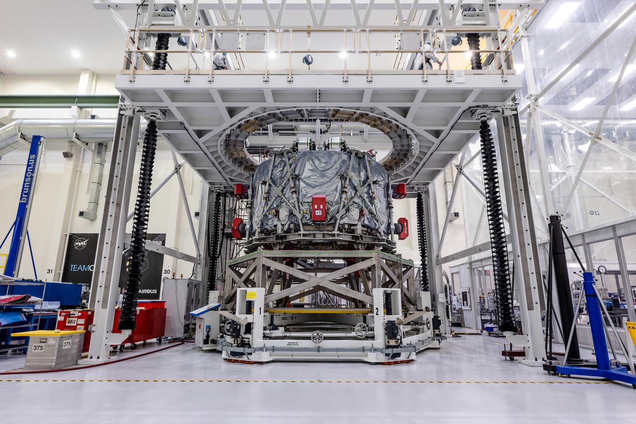 The crew module adapter, which connects Orion's crew module with the European Service Module, is lifted in preparation for mating with the Artemis II service module at Kennedy Space Center on Feb. 11, 2020.