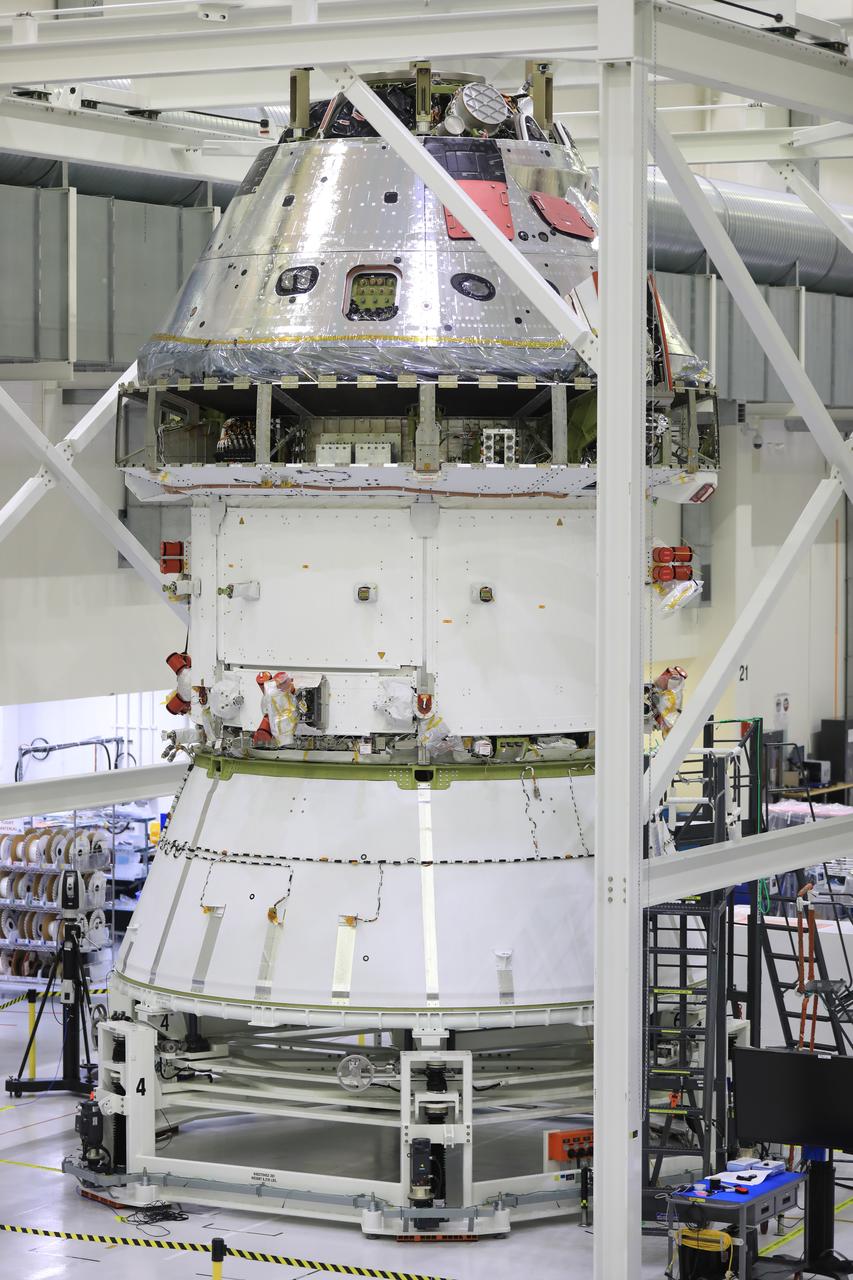 Installation of the spacecraft adapter (SA) cone to the Artemis I Orion spacecraft shown in progress inside the Neil Armstrong Operations and Checkout Building on Aug. 10, 2020. This is one of the final major hardware operations the spacecraft will undergo during closeout processing prior to being integrated with the Space Launch System (SLS) rocket in preparation for the first Artemis mission. The spacecraft adapter cone connects the bottom portion of Orion’s service module to the top part of the rocket known as the interim cryogenic propulsion stage (ICPS). Orion will fly on the agency’s Artemis I mission – the first in a series of increasingly complex missions to the Moon that will ultimately lead to the exploration of Mars.