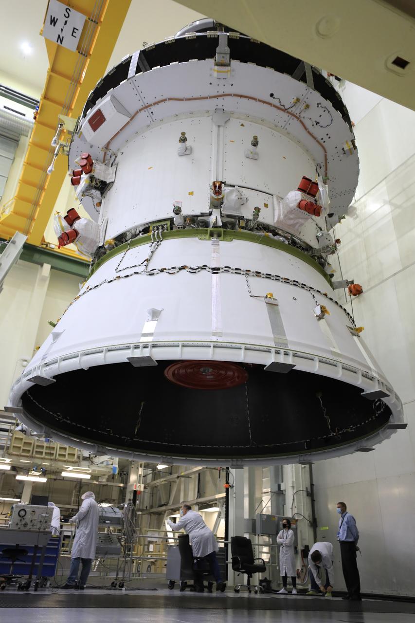 The Artemis I Orion spacecraft with its spacecraft adapter cone attached, is moved by crane along the high bay inside the Neil Armstrong Operations and Checkout Building at NASA’s Kennedy Space Center in Florida on Aug. 20, 2020. This is one of the final major hardware operations the spacecraft will undergo during closeout processing prior to being integrated with the Space Launch System (SLS) rocket in preparation for the first Artemis mission. The spacecraft adapter cone connects the bottom portion of Orion’s service module to the top part of the rocket known as the interim cryogenic propulsion stage (ICPS). Orion will fly on the agency’s Artemis I mission – the first in a series of increasingly complex missions to the Moon that will ultimately lead to the exploration of Mars.