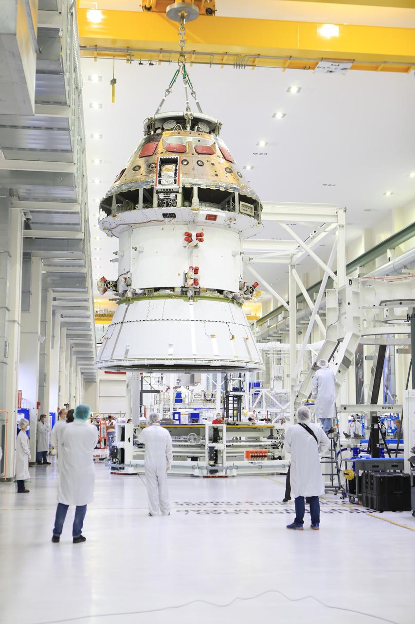 The Artemis I Orion spacecraft with its spacecraft adapter cone attached, is moved by crane along the high bay inside the Neil Armstrong Operations and Checkout Building at NASA’s Kennedy Space Center in Florida on Aug. 20, 2020. This is one of the final major hardware operations the spacecraft will undergo during closeout processing prior to being integrated with the Space Launch System (SLS) rocket in preparation for the first Artemis mission. The spacecraft adapter cone connects the bottom portion of Orion’s service module to the top part of the rocket known as the interim cryogenic propulsion stage (ICPS). Orion will fly on the agency’s Artemis I mission – the first in a series of increasingly complex missions to the Moon that will ultimately lead to the exploration of Mars.