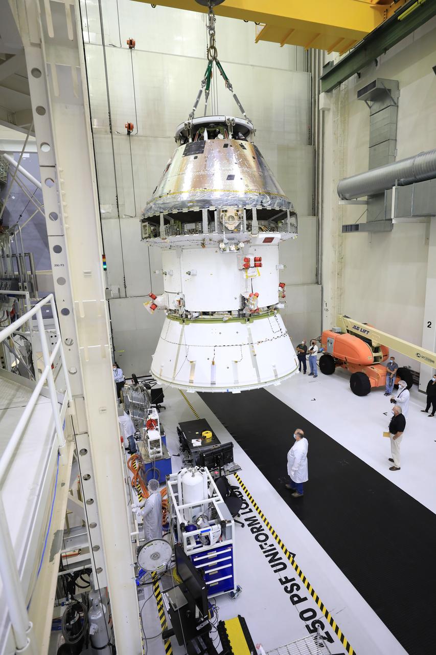 The Artemis I Orion spacecraft with its spacecraft adapter cone attached, is moved by crane along the high bay inside the Neil Armstrong Operations and Checkout Building at NASA’s Kennedy Space Center in Florida on Aug. 20, 2020. This is one of the final major hardware operations the spacecraft will undergo during closeout processing prior to being integrated with the Space Launch System (SLS) rocket in preparation for the first Artemis mission. The spacecraft adapter cone connects the bottom portion of Orion’s service module to the top part of the rocket known as the interim cryogenic propulsion stage (ICPS). Orion will fly on the agency’s Artemis I mission – the first in a series of increasingly complex missions to the Moon that will ultimately lead to the exploration of Mars.
