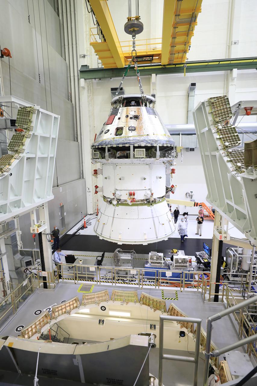 The Artemis I Orion spacecraft with its spacecraft adapter cone attached, is moved by crane along the high bay inside the Neil Armstrong Operations and Checkout Building at NASA’s Kennedy Space Center in Florida on Aug. 20, 2020. This is one of the final major hardware operations the spacecraft will undergo during closeout processing prior to being integrated with the Space Launch System (SLS) rocket in preparation for the first Artemis mission. The spacecraft adapter cone connects the bottom portion of Orion’s service module to the top part of the rocket known as the interim cryogenic propulsion stage (ICPS). Orion will fly on the agency’s Artemis I mission – the first in a series of increasingly complex missions to the Moon that will ultimately lead to the exploration of Mars.
