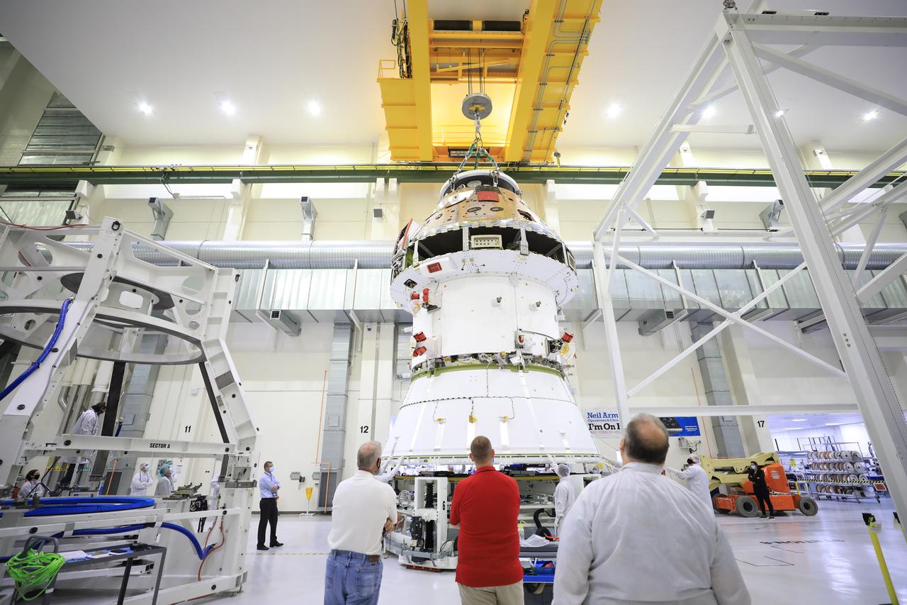The Artemis I Orion spacecraft with its spacecraft adapter cone attached, is moved by crane along the high bay inside the Neil Armstrong Operations and Checkout Building at NASA’s Kennedy Space Center in Florida on Aug. 20, 2020. This is one of the final major hardware operations the spacecraft will undergo during closeout processing prior to being integrated with the Space Launch System (SLS) rocket in preparation for the first Artemis mission. The spacecraft adapter cone connects the bottom portion of Orion’s service module to the top part of the rocket known as the interim cryogenic propulsion stage (ICPS). Orion will fly on the agency’s Artemis I mission – the first in a series of increasingly complex missions to the Moon that will ultimately lead to the exploration of Mars.