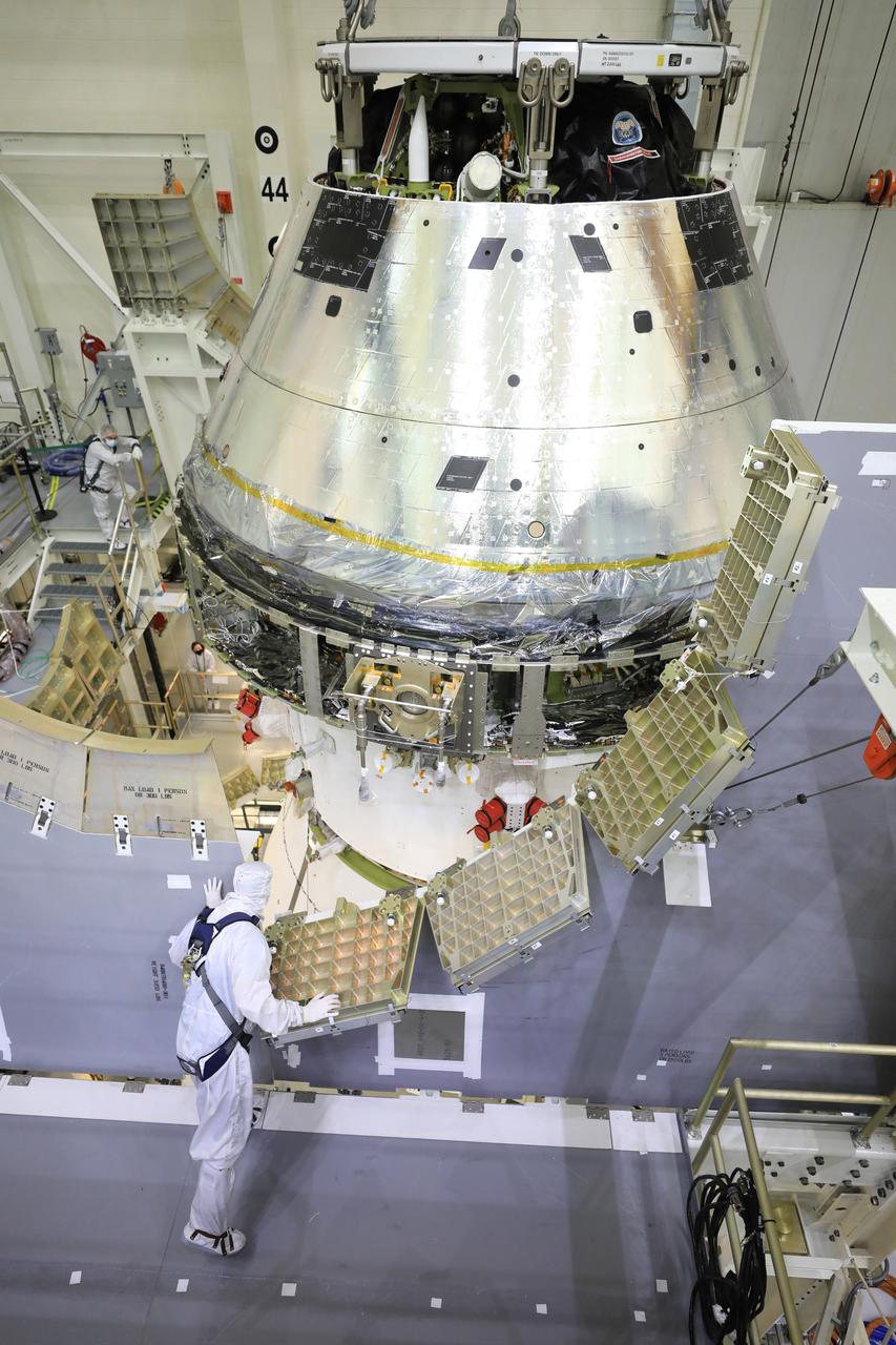 Technicians at NASA’s Kennedy Space Center in Florida work to safely lower the Artemis I Orion spacecraft into the FAST cell after completing the installation of the spacecraft adapter (SA) cone inside the Neil Armstrong Operations and Checkout Building on Aug. 20, 2020. This is one of the final major hardware operations the spacecraft will undergo during closeout processing prior to being integrated with the Space Launch System (SLS) rocket in preparation for the first Artemis mission. The spacecraft adapter cone connects the bottom portion of Orion’s service module to the top part of the rocket known as the interim cryogenic propulsion stage (ICPS). Orion will fly on the agency’s Artemis I mission – the first in a series of increasingly complex missions to the Moon that will ultimately lead to the exploration of Mars.