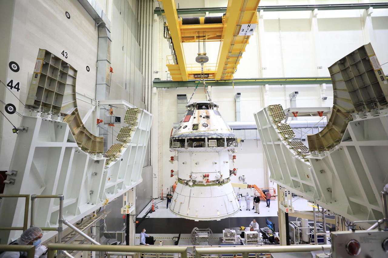 The Artemis I Orion spacecraft with its spacecraft adapter cone attached, is moved by crane into the FAST cell inside the Neil Armstrong Operations and Checkout Building at NASA’s Kennedy Space Center in Florida on Aug. 20, 2020. This is one of the final major hardware operations the spacecraft will undergo during closeout processing prior to being integrated with the Space Launch System (SLS) rocket in preparation for the first Artemis mission. The spacecraft adapter cone connects the bottom portion of Orion’s service module to the top part of the rocket known as the interim cryogenic propulsion stage (ICPS). Orion will fly on the agency’s Artemis I mission – the first in a series of increasingly complex missions to the Moon that will ultimately lead to the exploration of Mars.