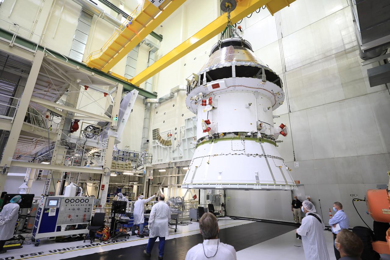 The Artemis I Orion spacecraft with its spacecraft adapter cone attached, is moved by crane along the high bay inside the Neil Armstrong Operations and Checkout Building at NASA’s Kennedy Space Center in Florida on Aug. 20, 2020. This is one of the final major hardware operations the spacecraft will undergo during closeout processing prior to being integrated with the Space Launch System (SLS) rocket in preparation for the first Artemis mission. The spacecraft adapter cone connects the bottom portion of Orion’s service module to the top part of the rocket known as the interim cryogenic propulsion stage (ICPS). Orion will fly on the agency’s Artemis I mission – the first in a series of increasingly complex missions to the Moon that will ultimately lead to the exploration of Mars.