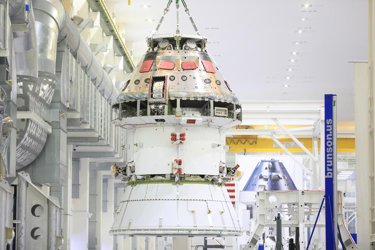 The Artemis I Orion spacecraft with its spacecraft adapter cone attached, is moved by crane along the high bay inside the Neil Armstrong Operations and Checkout Building at NASA’s Kennedy Space Center in Florida on Aug. 20, 2020. This is one of the final major hardware operations the spacecraft will undergo during closeout processing prior to being integrated with the Space Launch System (SLS) rocket in preparation for the first Artemis mission. The spacecraft adapter cone connects the bottom portion of Orion’s service module to the top part of the rocket known as the interim cryogenic propulsion stage (ICPS). Orion will fly on the agency’s Artemis I mission – the first in a series of increasingly complex missions to the Moon that will ultimately lead to the exploration of Mars.