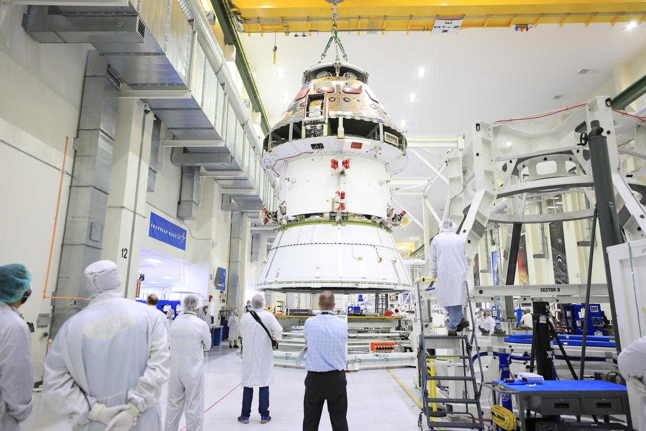The Artemis I Orion spacecraft with its spacecraft adapter cone attached, is moved by crane along the high bay inside the Neil Armstrong Operations and Checkout Building at NASA’s Kennedy Space Center in Florida on Aug. 20, 2020. This is one of the final major hardware operations the spacecraft will undergo during closeout processing prior to being integrated with the Space Launch System (SLS) rocket in preparation for the first Artemis mission. The spacecraft adapter cone connects the bottom portion of Orion’s service module to the top part of the rocket known as the interim cryogenic propulsion stage (ICPS). Orion will fly on the agency’s Artemis I mission – the first in a series of increasingly complex missions to the Moon that will ultimately lead to the exploration of Mars.