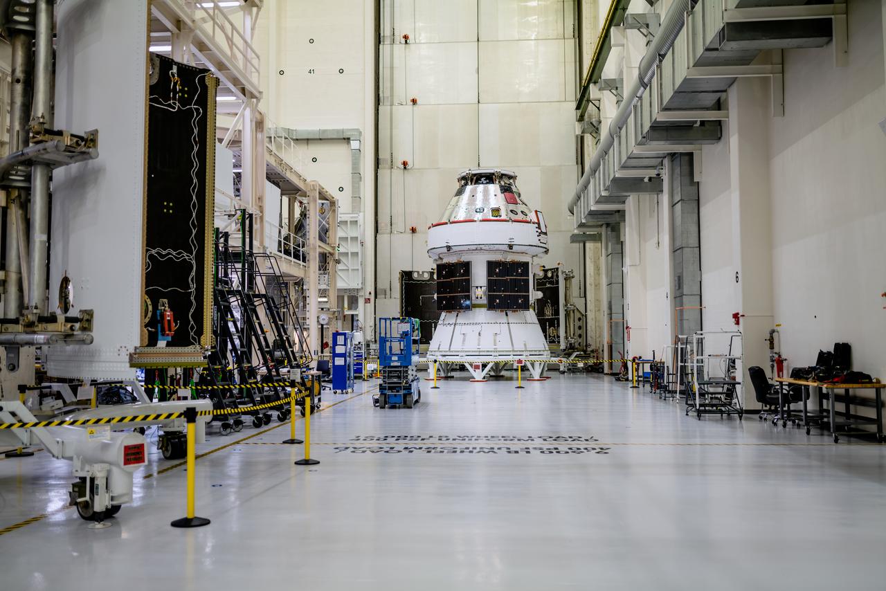 In the Operations and Checkout Building (O&amp;C) at Kennedy Space Center, three spacecraft adapter jettison (SAJ) fairings are prepared for installation and will be moved into place by technicians with Lockheed Martin, lead contractor for Orion on Oct. 12, 2020. They will be secured around the spacecraft, encapsulating the European Service Module to protect it from the harsh environment as the spacecraft is propelled out of Earth’s atmosphere atop the Space Launch System (SLS) rocket during NASA’s Artemis I mission. The next time the solar array wings will be visible will be when Orion is in space. Artemis I will test the Orion spacecraft and SLS as an integrated system ahead of crewed flights to the Moon.