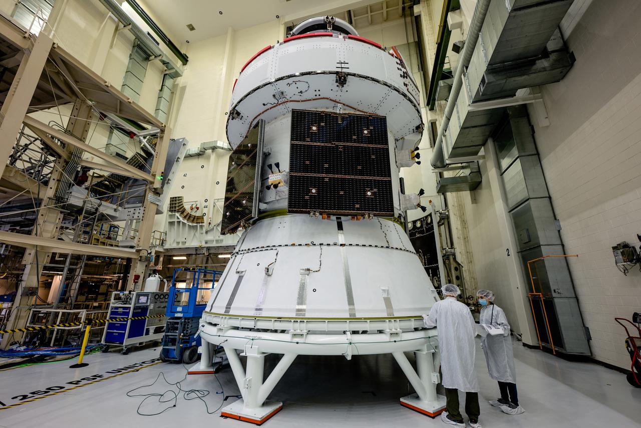 In the Operations and Checkout Building (O&amp;C) at Kennedy Space Center, three spacecraft adapter jettison (SAJ) fairings are prepared for installation and will be moved into place by technicians with Lockheed Martin, lead contractor for Orion on Oct. 12, 2020. They will be secured around the spacecraft, encapsulating the European Service Module to protect it from the harsh environment as the spacecraft is propelled out of Earth’s atmosphere atop the Space Launch System (SLS) rocket during NASA’s Artemis I mission. The next time the solar array wings will be visible will be when Orion is in space. Artemis I will test the Orion spacecraft and SLS as an integrated system ahead of crewed flights to the Moon.